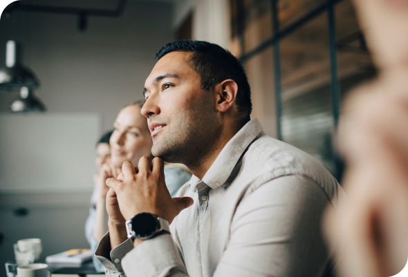 People at a conference table listening